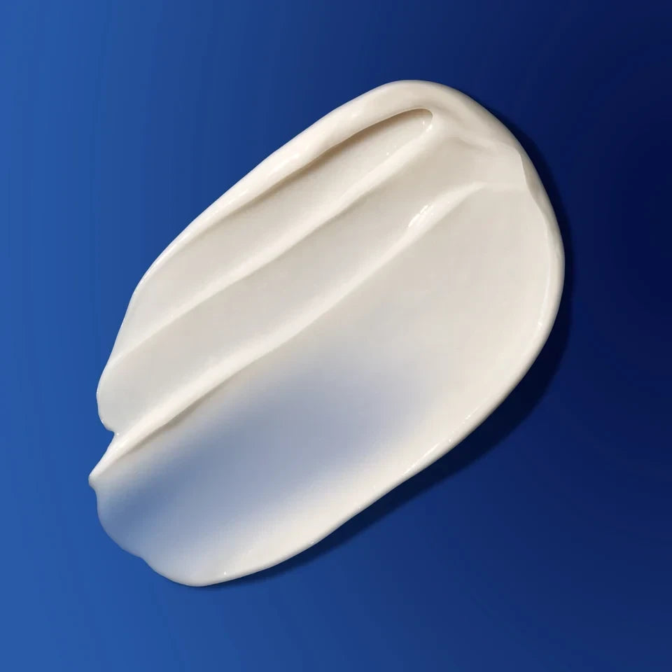 Shop Rescue Spa The Overnight Restorative Cream rich white moisturizer texture swatch against a deep blue background