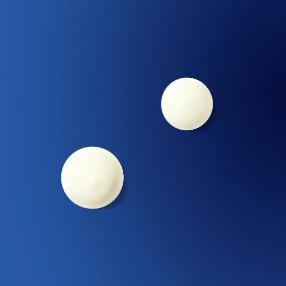 Shop Rescue Spa The Retinol Serum texture shown as two creamy white drops against a deep blue background