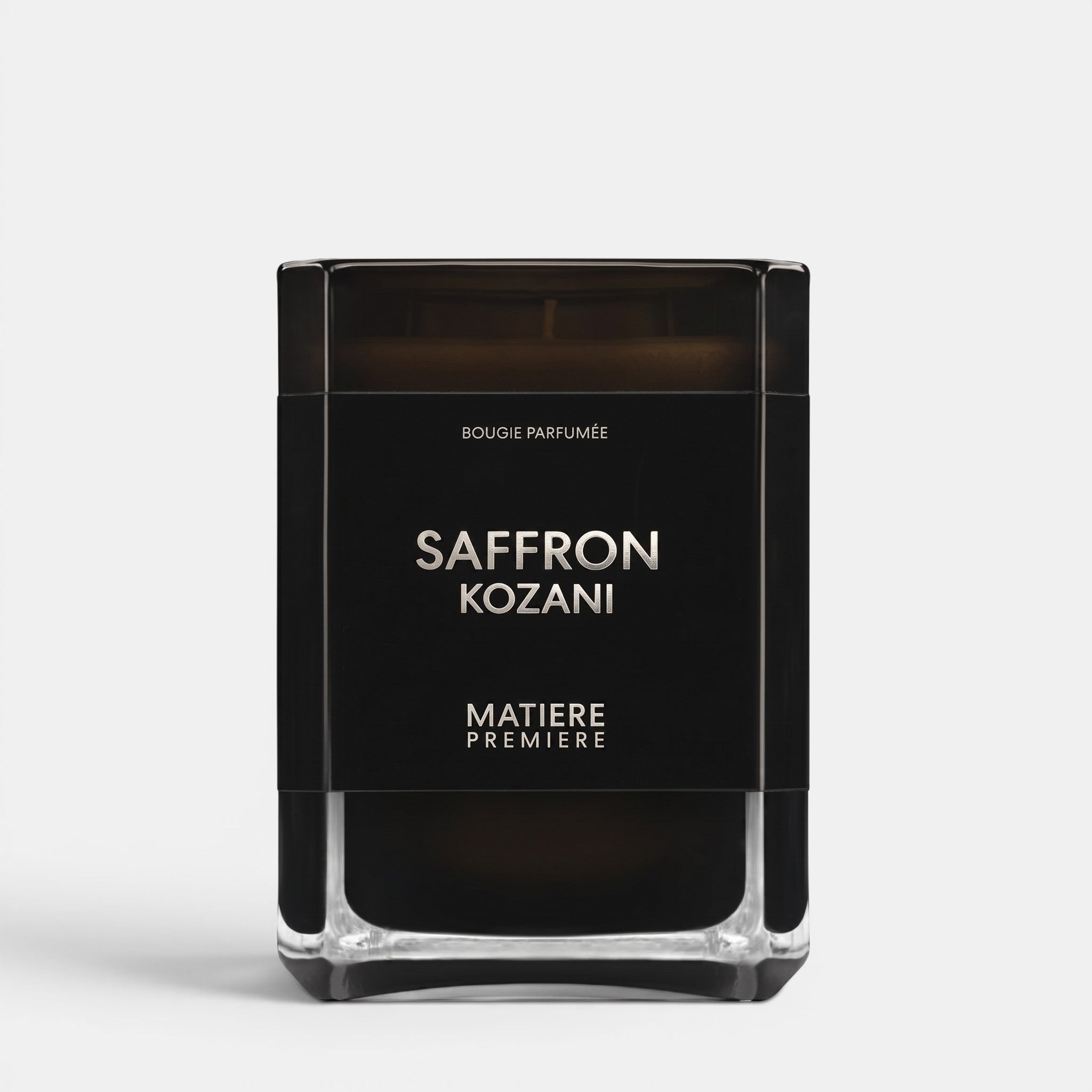 Shop Rescue Spa Saffron Kozani scented candle in a sleek black glass jar with minimalist white typography.