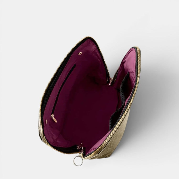 Shop Rescue Spa Signature Makeup Bag in olive green leather with a burgundy interior, featuring multiple compartments and a zip-out liner.