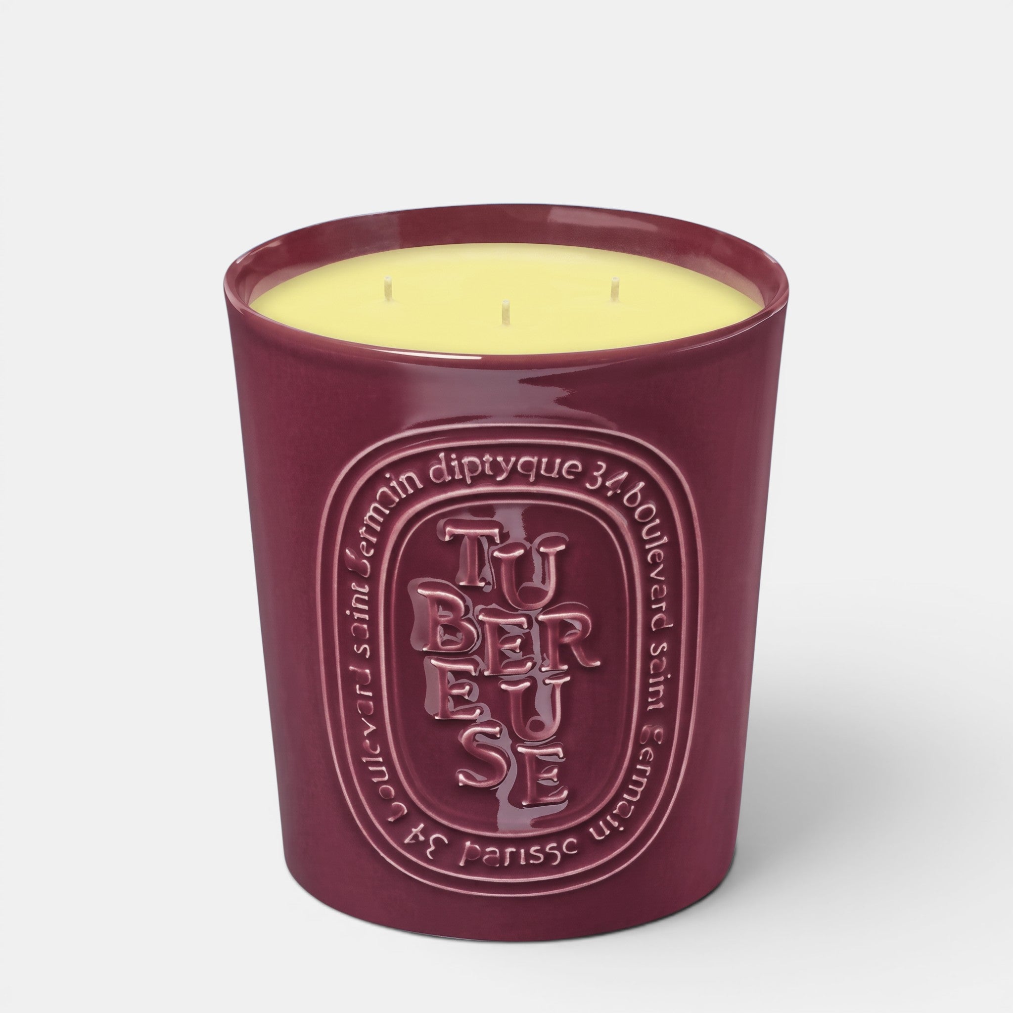 Shop Rescue Spa Tubereuse scented candle in a deep burgundy ceramic vessel with embossed lettering and yellow wax.