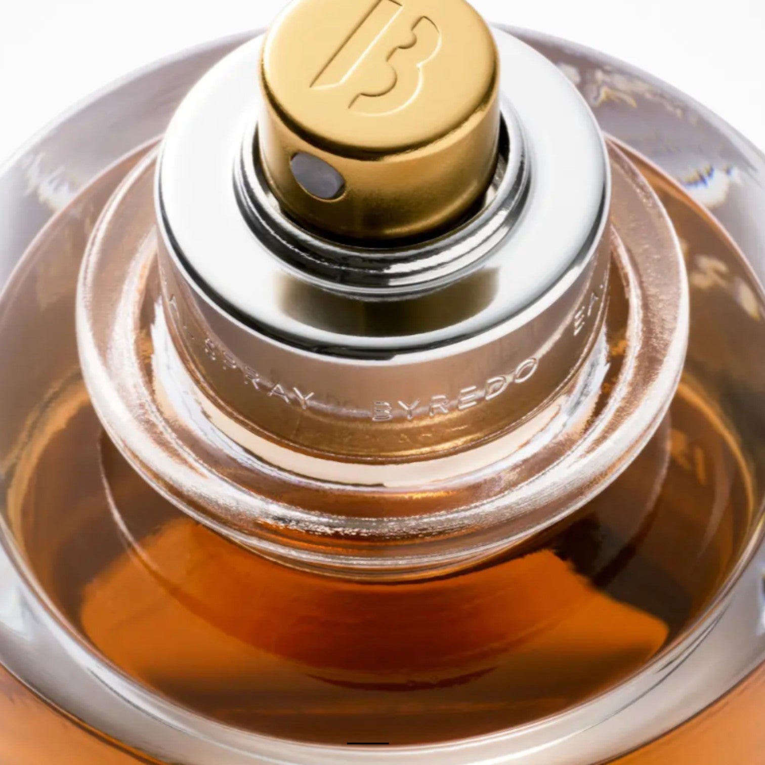 Shop Rescue Spa Vanille Antique Extrait De Parfum, amber-toned fragrance in a clear glass bottle with gold and silver cap.