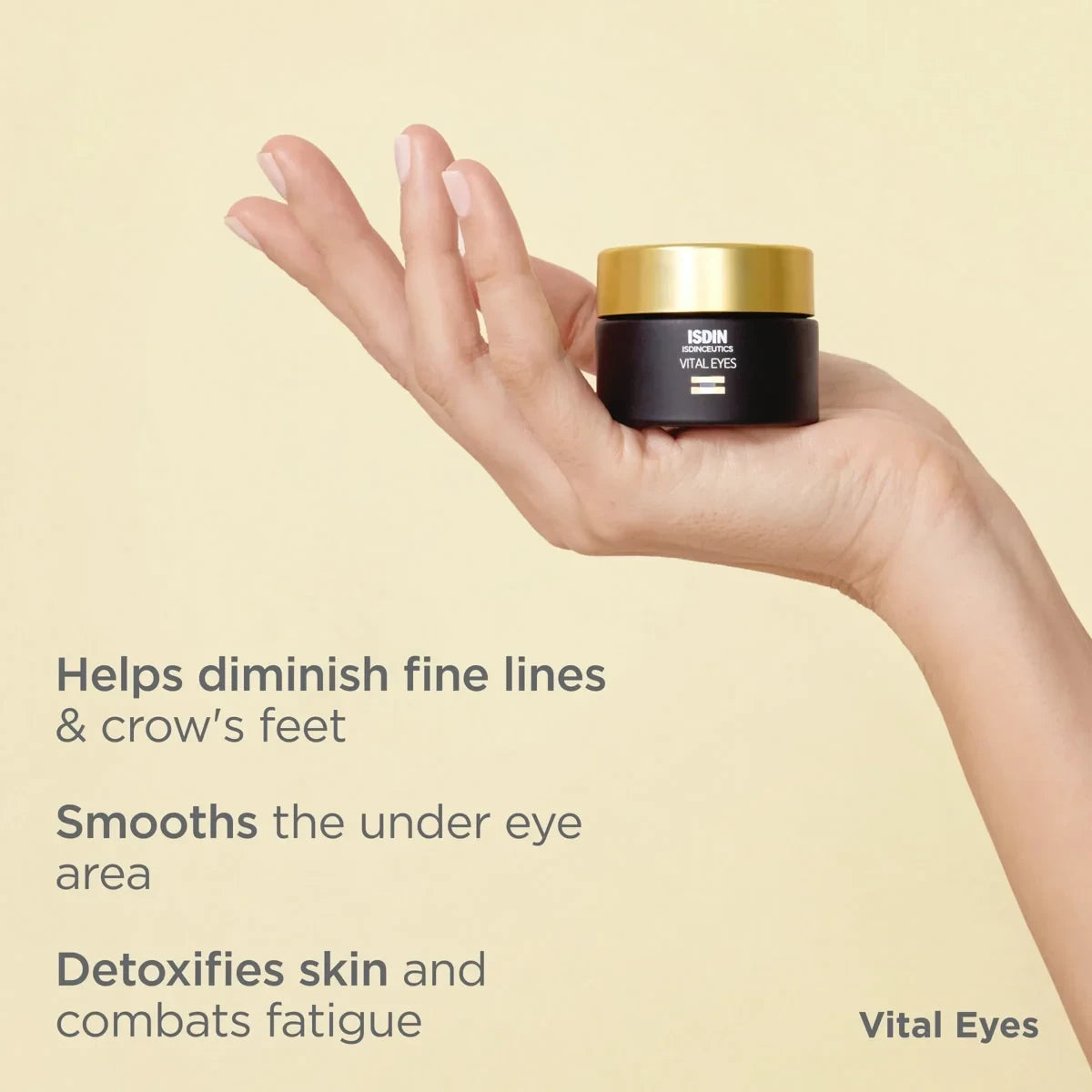 Shop Rescue Spa Isdinceutics Vital Eyes repair cream jar held in a hand against a soft yellow background