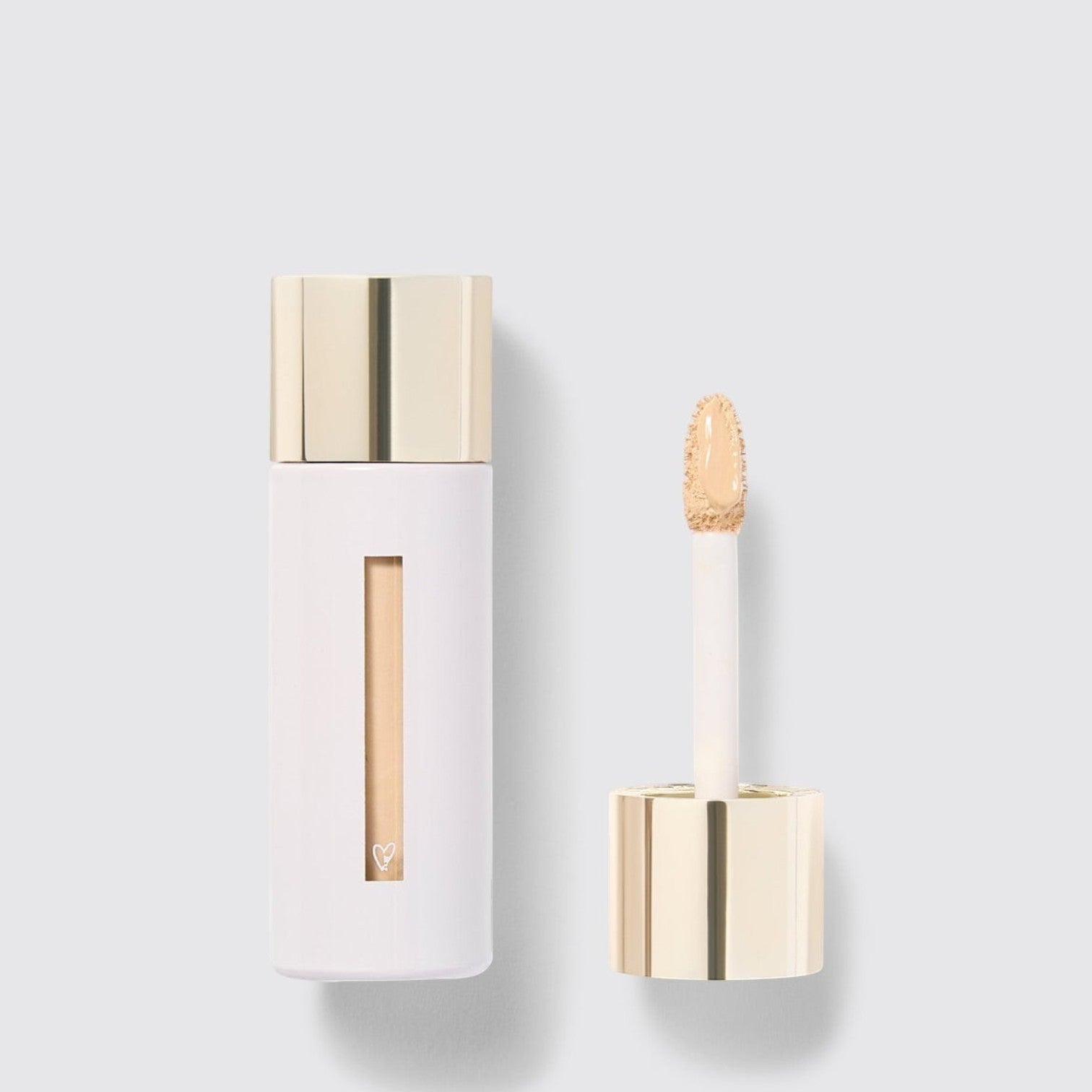 Shop Rescue Spa Westman Atelier Vital Skincare Concealer in a white bottle with a gold cap and doe-foot applicator.