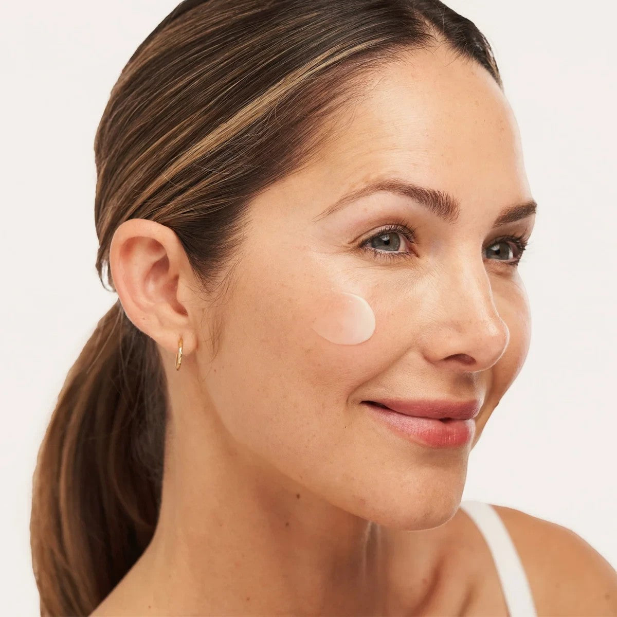Shop Rescue Spa C-RADICAL Defense antioxidant serum applied as a small dot on a woman&