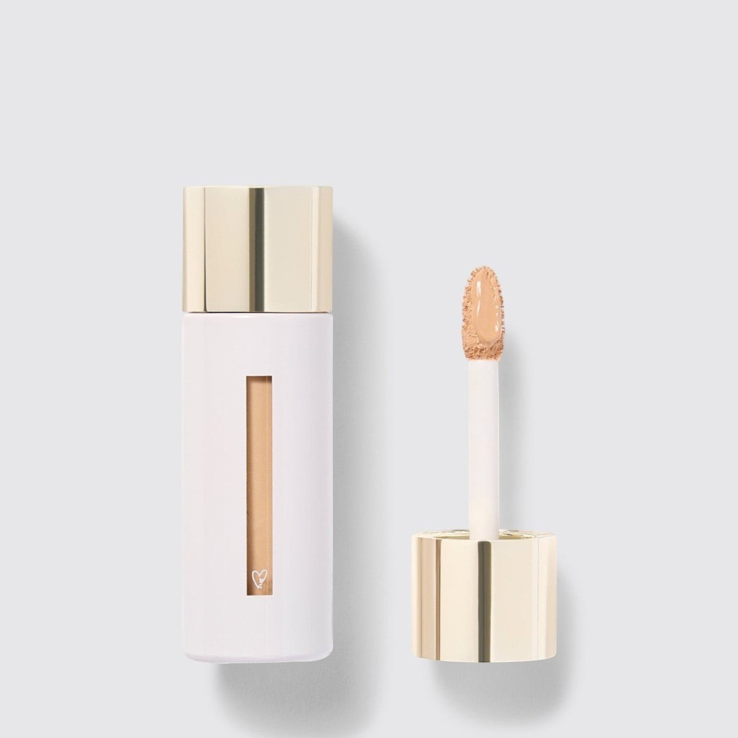 Shop Rescue Spa Westman Atelier Vital Skincare Concealer in a white bottle with a gold cap and doe-foot applicator