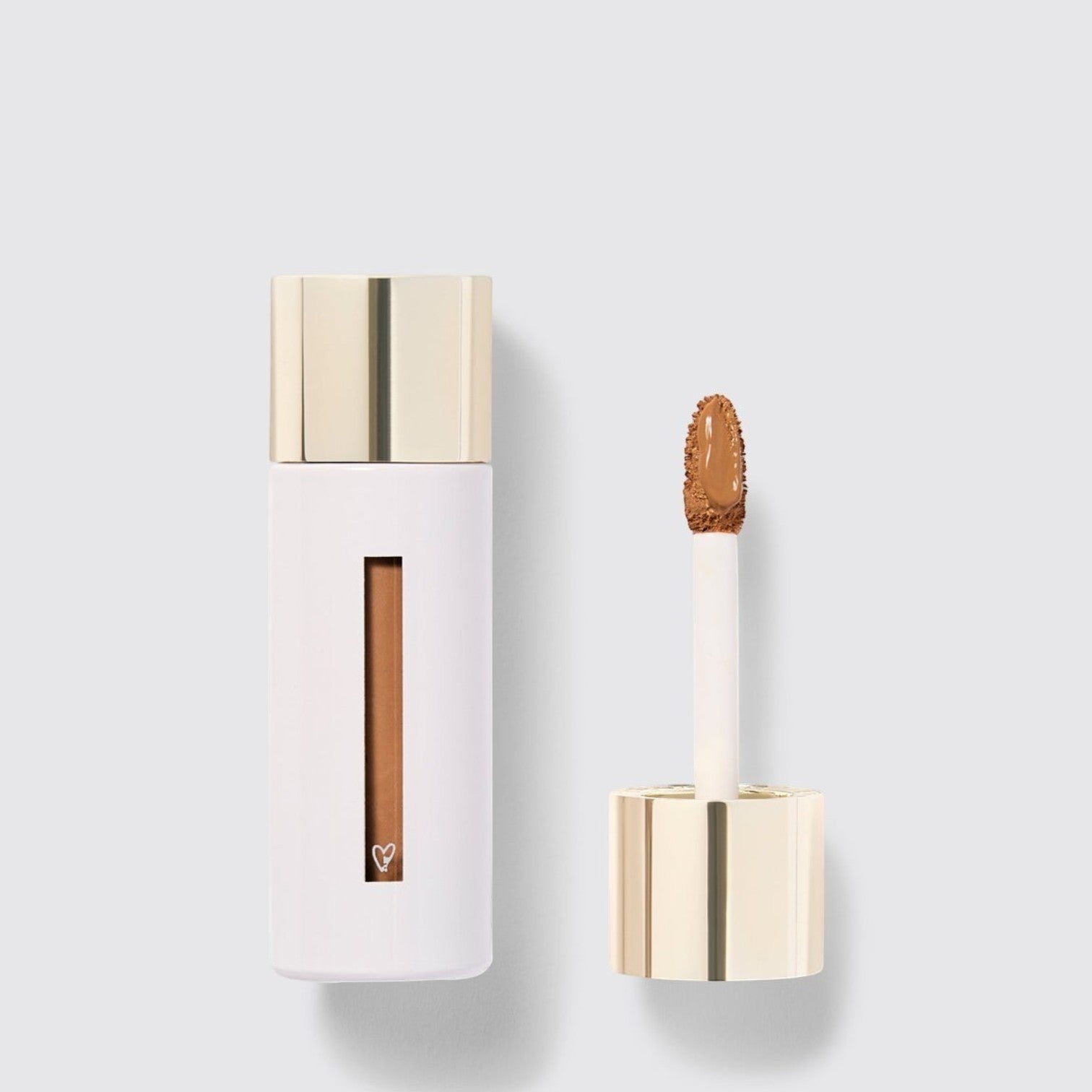 Shop Rescue Spa Westman Atelier Vital Skincare Concealer in a white bottle with a gold cap and doe-foot applicator.