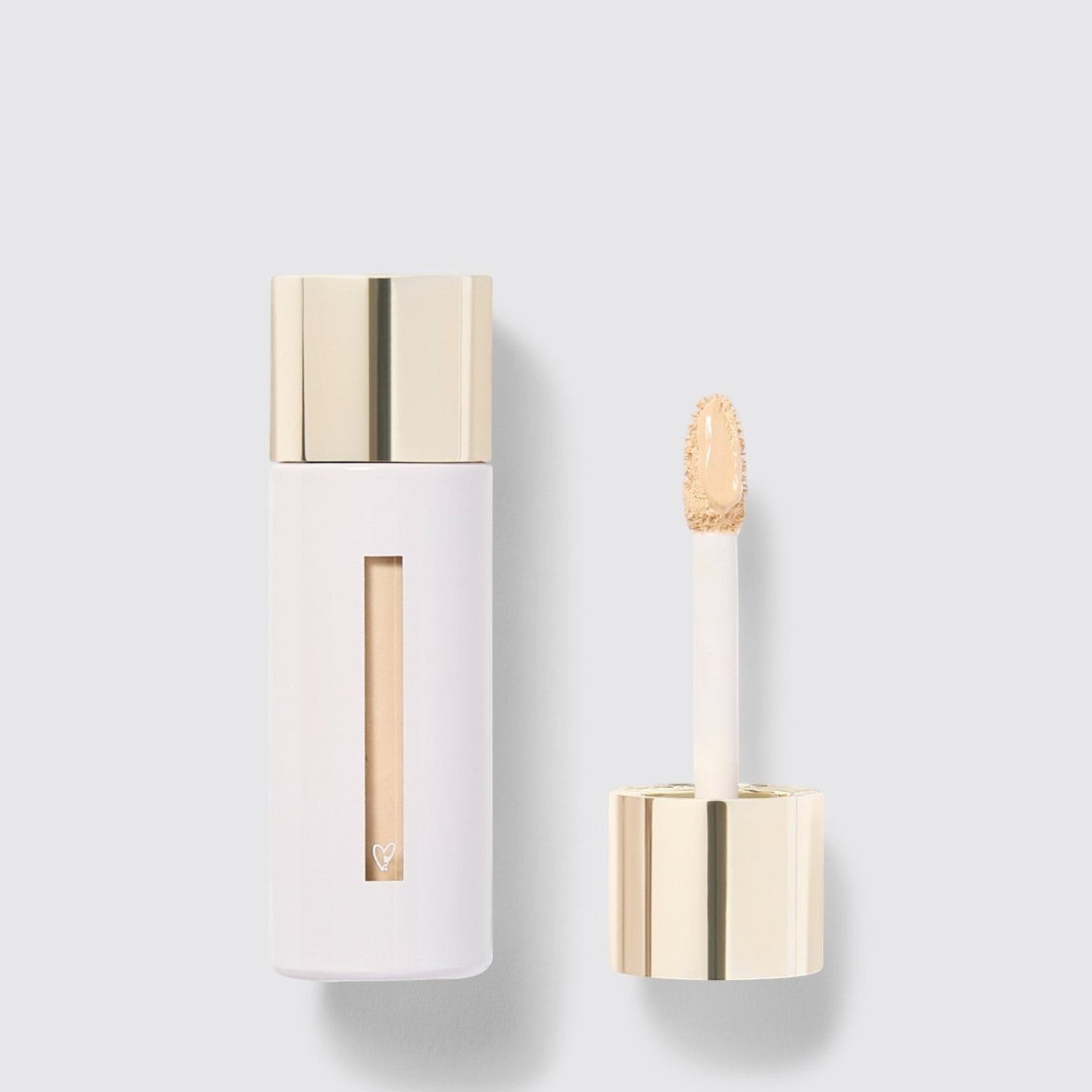 Shop Rescue Spa Westman Atelier Vital Skincare Concealer in a white bottle with a gold cap and doe-foot applicator