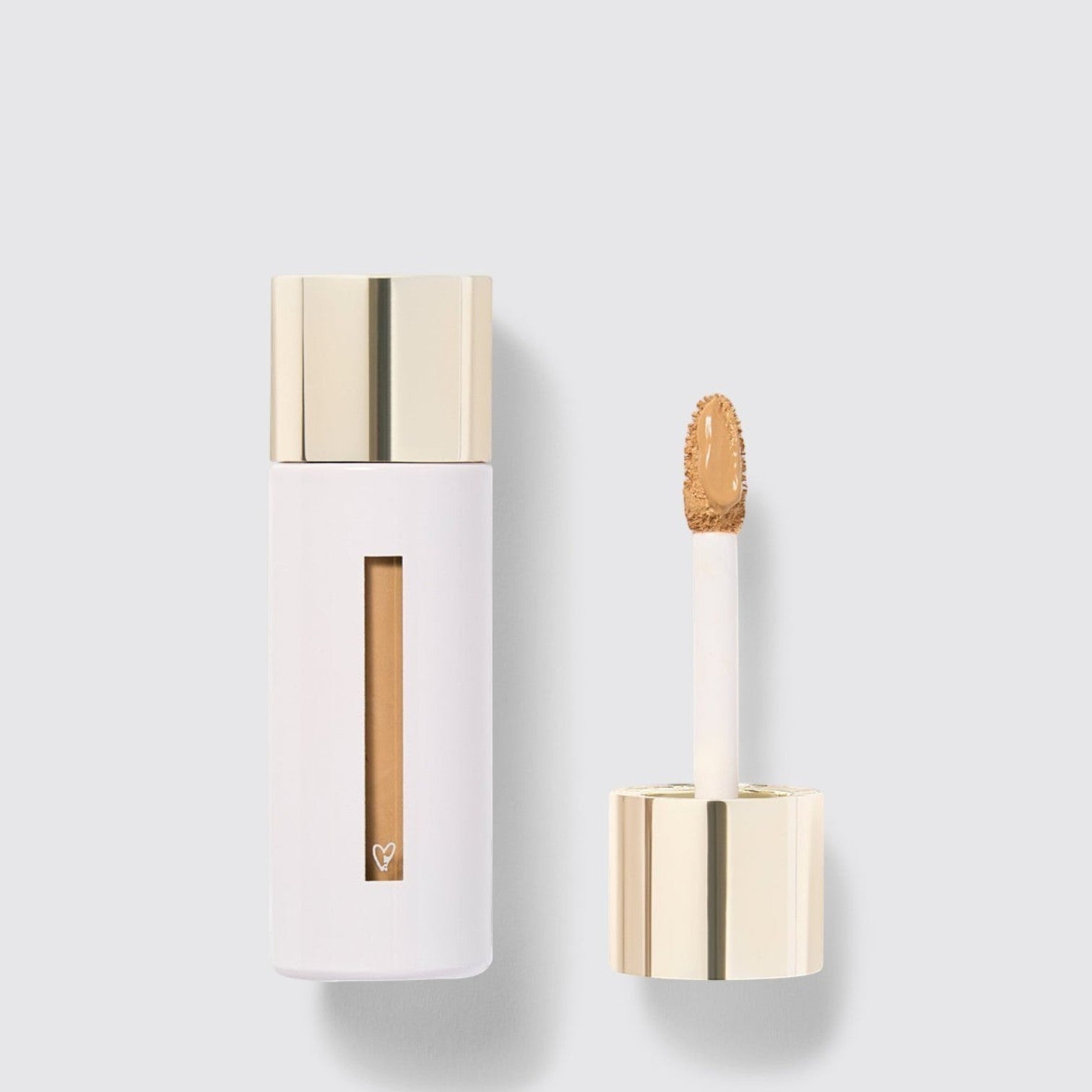 Shop Rescue Spa Westman Atelier Vital Skincare Concealer in a white bottle with a gold cap and doe-foot applicator