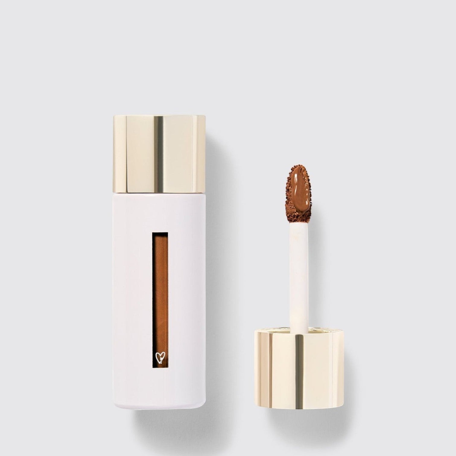 Shop Rescue Spa Westman Atelier Vital Skincare Concealer in a white bottle with a gold cap and doe-foot applicator