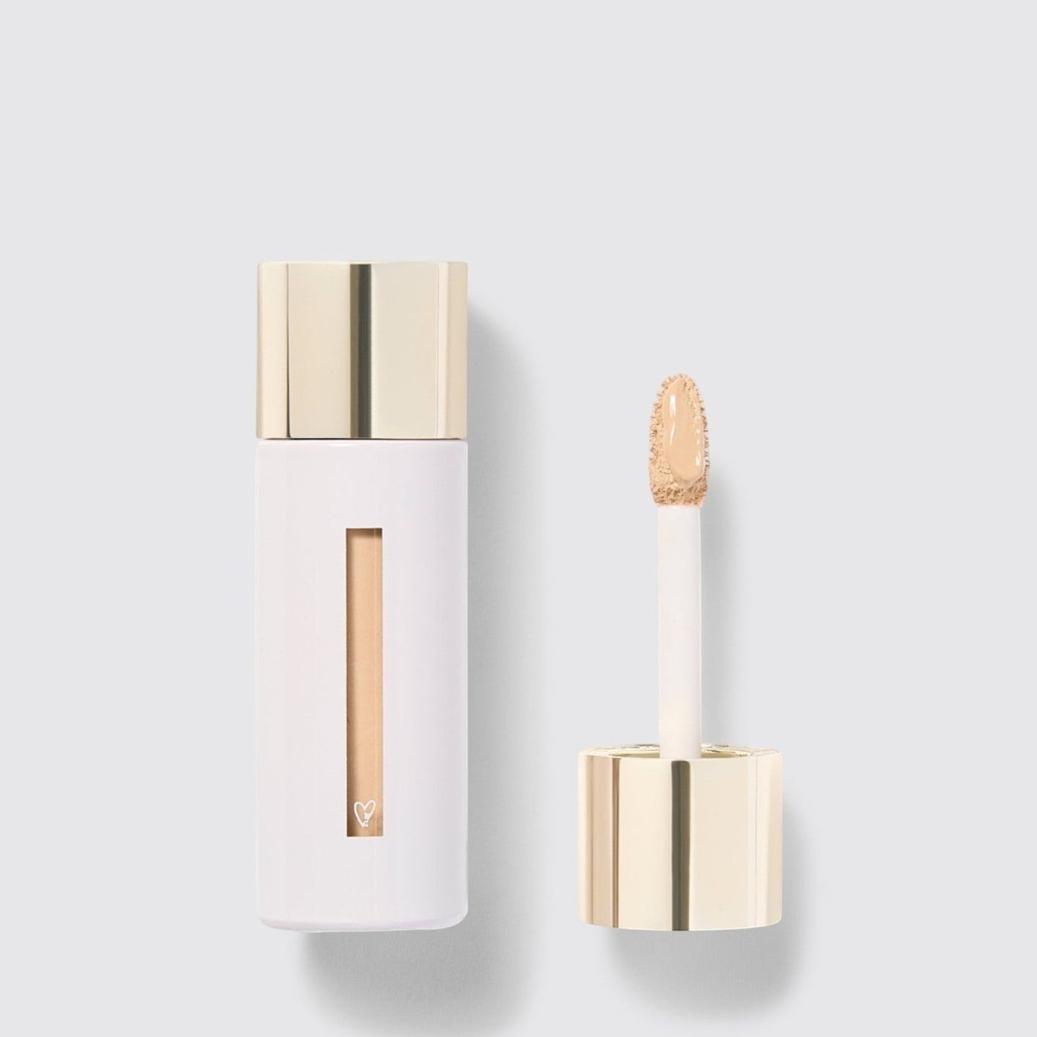 Shop Rescue Spa Westman Atelier Vital Skincare Concealer in a white bottle with a gold cap and doe-foot applicator.