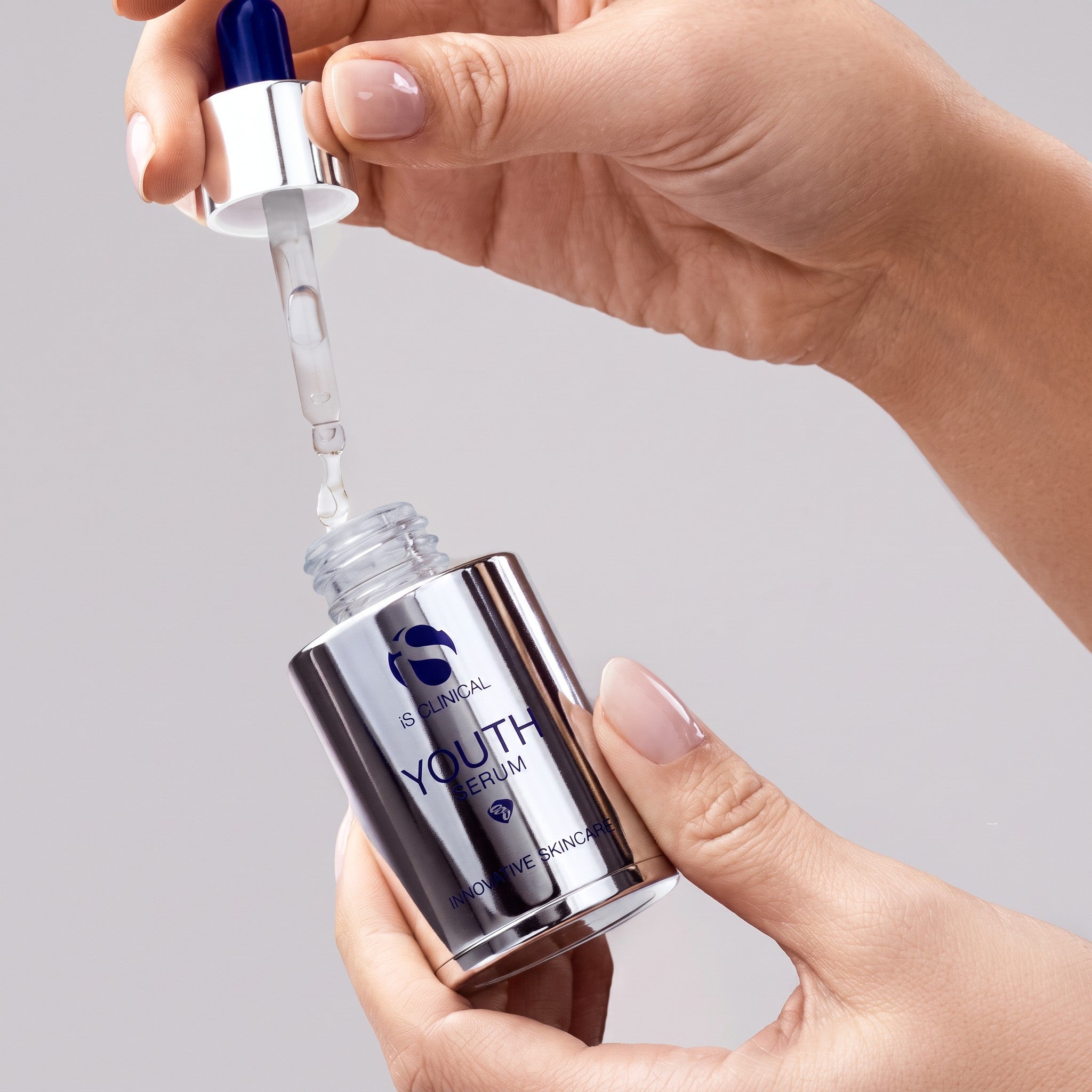 Shop Rescue Spa iS Clinical Youth Serum bottle with dropper dispensing clear anti-aging facial treatment