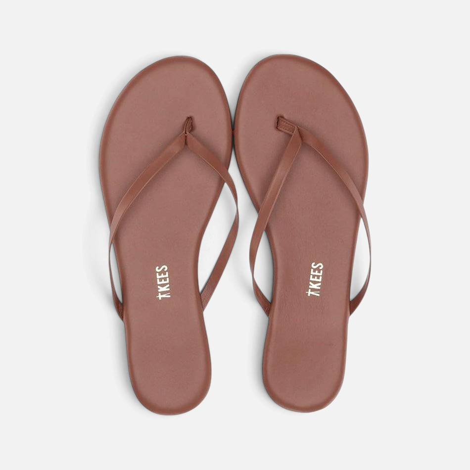 Shop Rescue Spa Foundations matte leather flip flops in cappuccino brown with a round toe and cushioned insole.