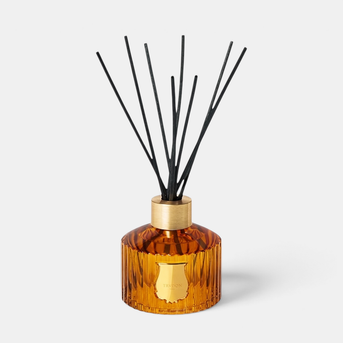 Shop Rescue Spa Le Diffuseur Altair with amber ribbed glass vessel, gold collar, and black reed diffuser sticks.