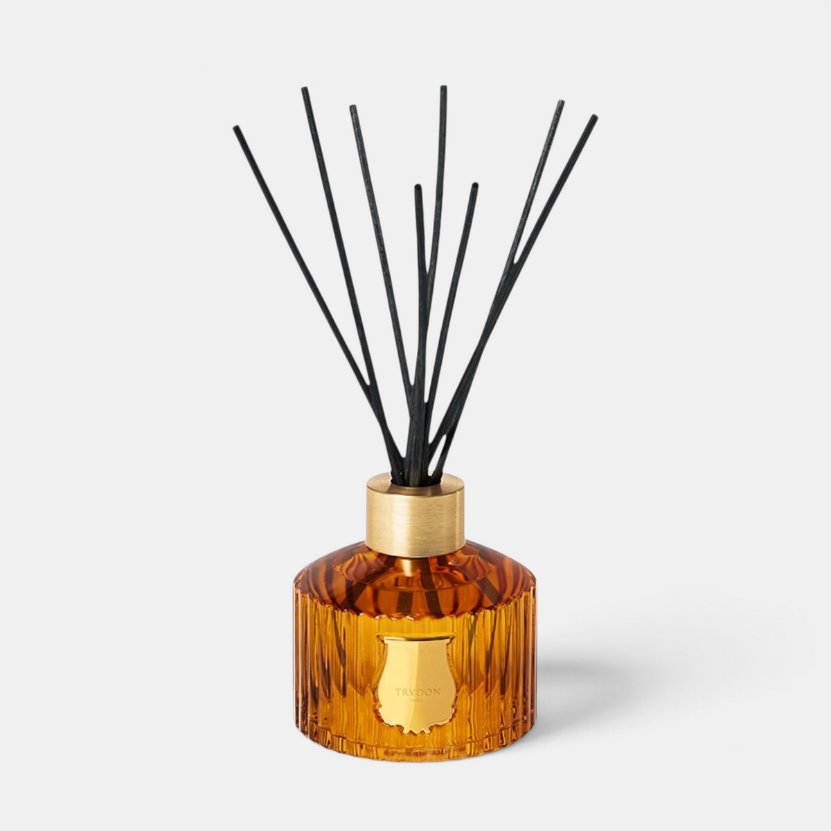 Shop Rescue Spa Le Diffuseur Altair with amber ribbed glass vessel, gold collar, and black reed diffuser sticks.