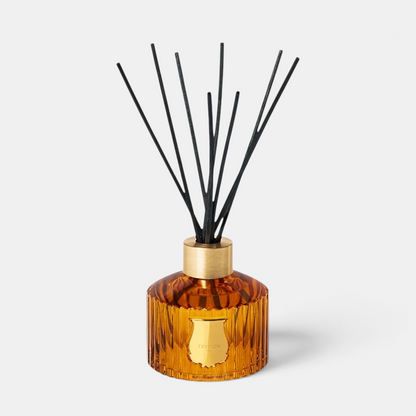 Shop Rescue Spa Le Diffuseur Altair with amber ribbed glass vessel, gold collar, and black reed diffuser sticks.