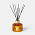 Shop Rescue Spa Le Diffuseur Altair with amber ribbed glass vessel, gold collar, and black reed diffuser sticks.