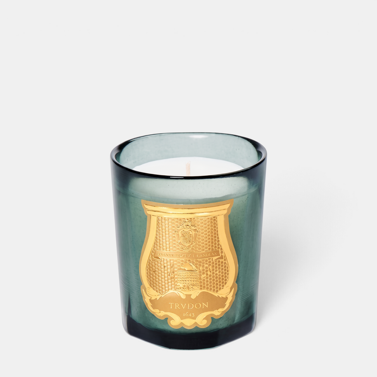 Shop Rescue Spa Figuerie candle in a green glass vessel with a gold Trudon emblem on a white background