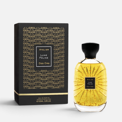 Shop Rescue Spa Lune Feline eau de parfum in a glass bottle with gold flakes next to its black and gold patterned box.