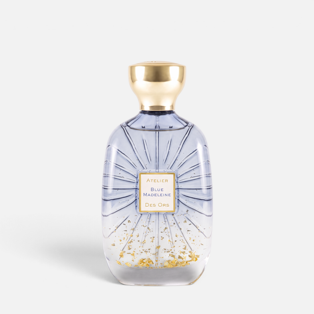 Shop Rescue Spa Atelier Des Ors Blue Madeleine perfume bottle with gold flakes and a gold cap on a white background.