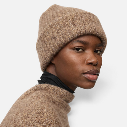 Shop Rescue Spa marled brown rib knit beanie made from a soft cashmere and silk blend worn by a model
