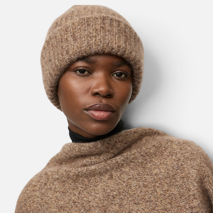 Shop Rescue Spa marled brown rib knit beanie made from a soft cashmere and silk blend worn by a model