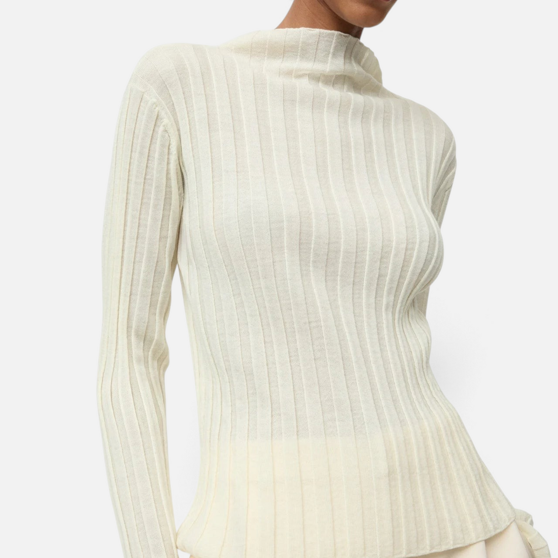 Shop Rescue Spa featherlight ribbed wool top in cream with a mock neck, worn by a model against a white background.