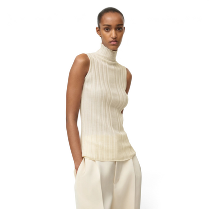 Model wearing a Shop Rescue Spa cream ribbed wool turtleneck singlet with a sleeveless design