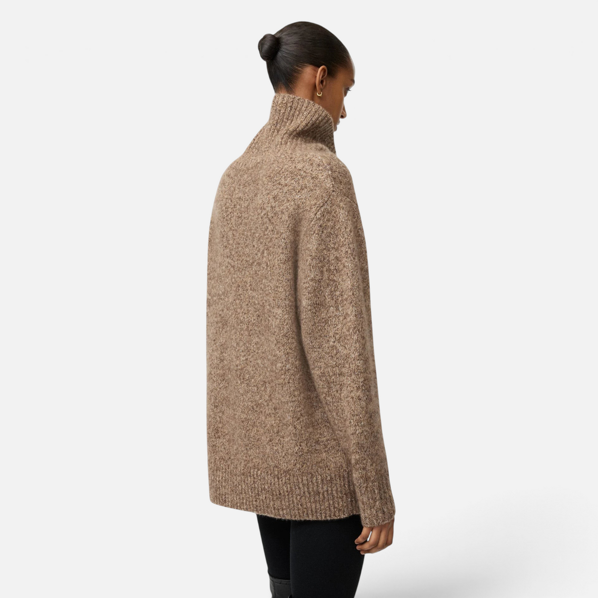 Model wearing a Shop Rescue Spa marled brown cashmere and silk turtleneck sweater with a relaxed fit