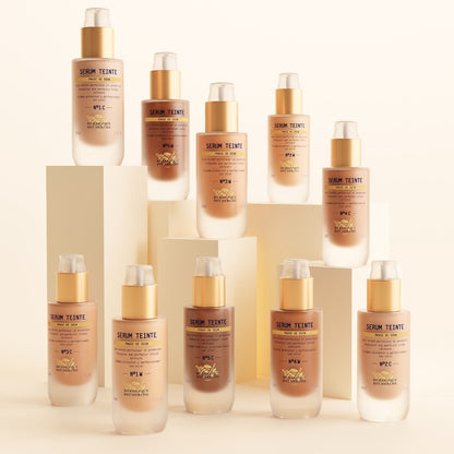 Multiple bottles of Serum Teinte on a beige background
