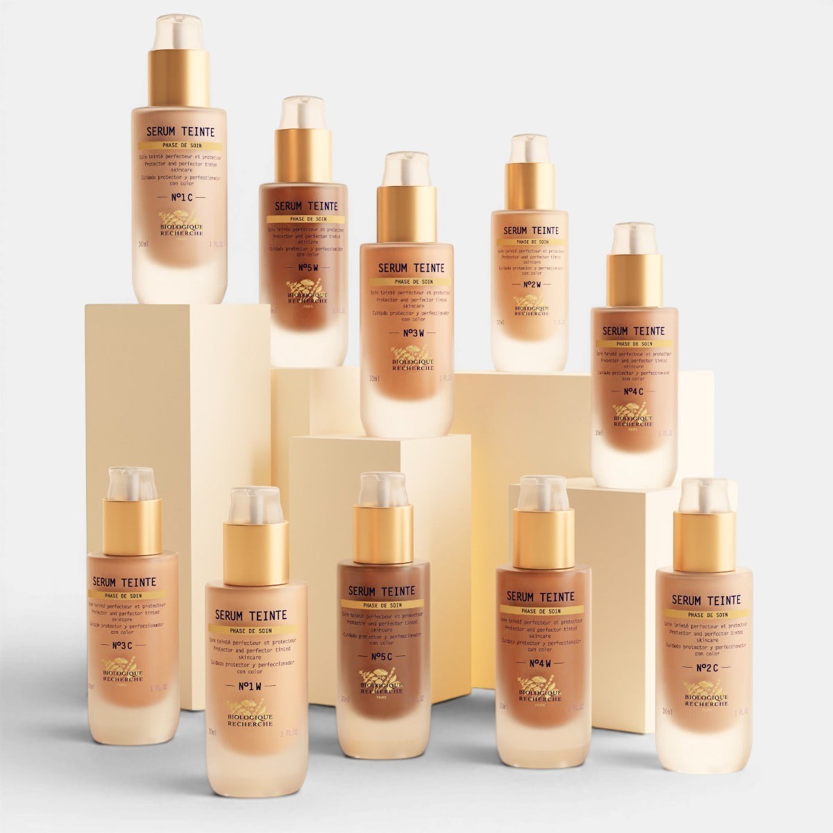 Multiple bottles of Serum Teinte on a beige background