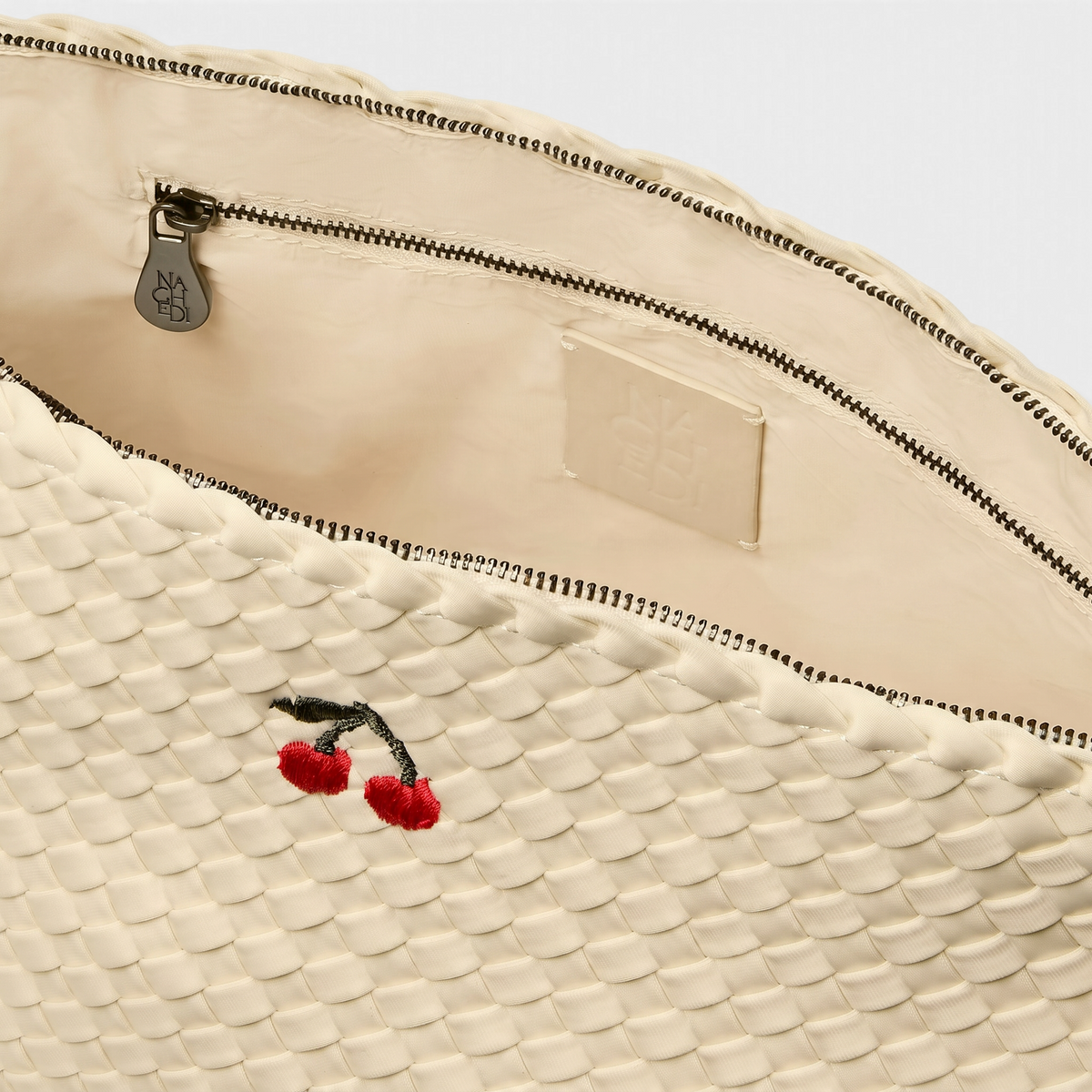 Shop Rescue Spa Portofino large cosmetic pouch in bone-white handwoven neoprene with an embroidered cherry motif.