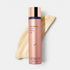 Shop Rescue Spa Even Intensive Skin Tone Correcting Serum in a rose gold bottle with a creamy serum swatch behind it.