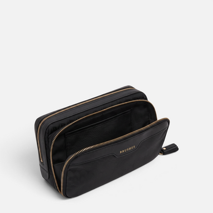 Shop Rescue Spa black Anya Hindmarch make-up pouch with gold zippers, patent leather trim, and BRUSHES embossed label