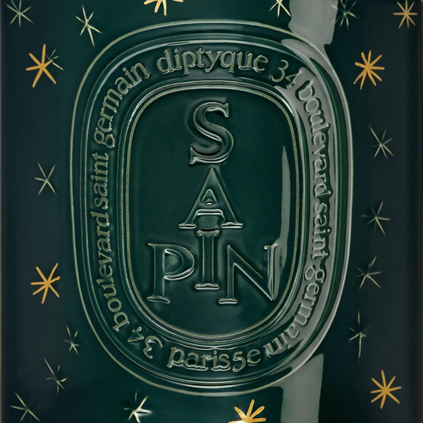 Shop Rescue Spa Diptyque Sapin holiday candle in dark green glass with gold star accents and embossed lettering