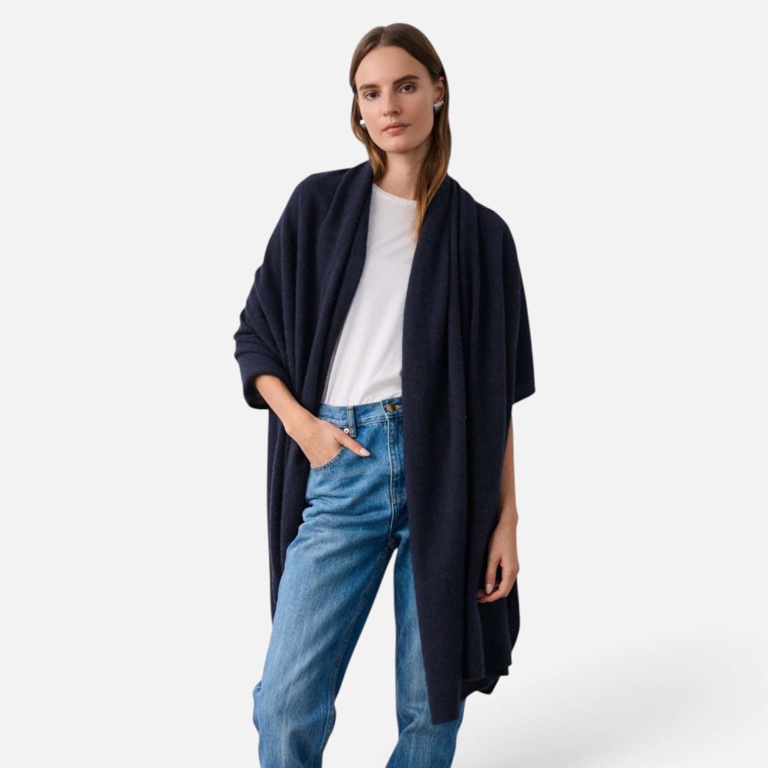 Shop Rescue Spa navy blue cashmere travel wrap worn by a woman over a white t-shirt and blue jeans