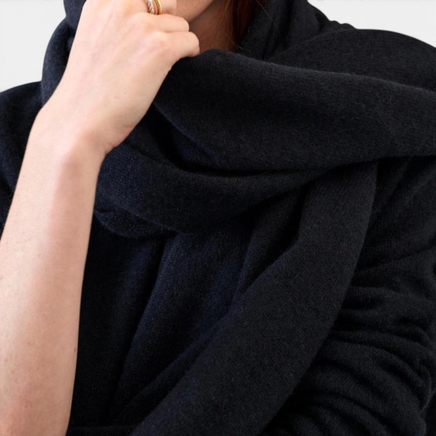 Shop Rescue Spa black cashmere travel wrap draped over a person&