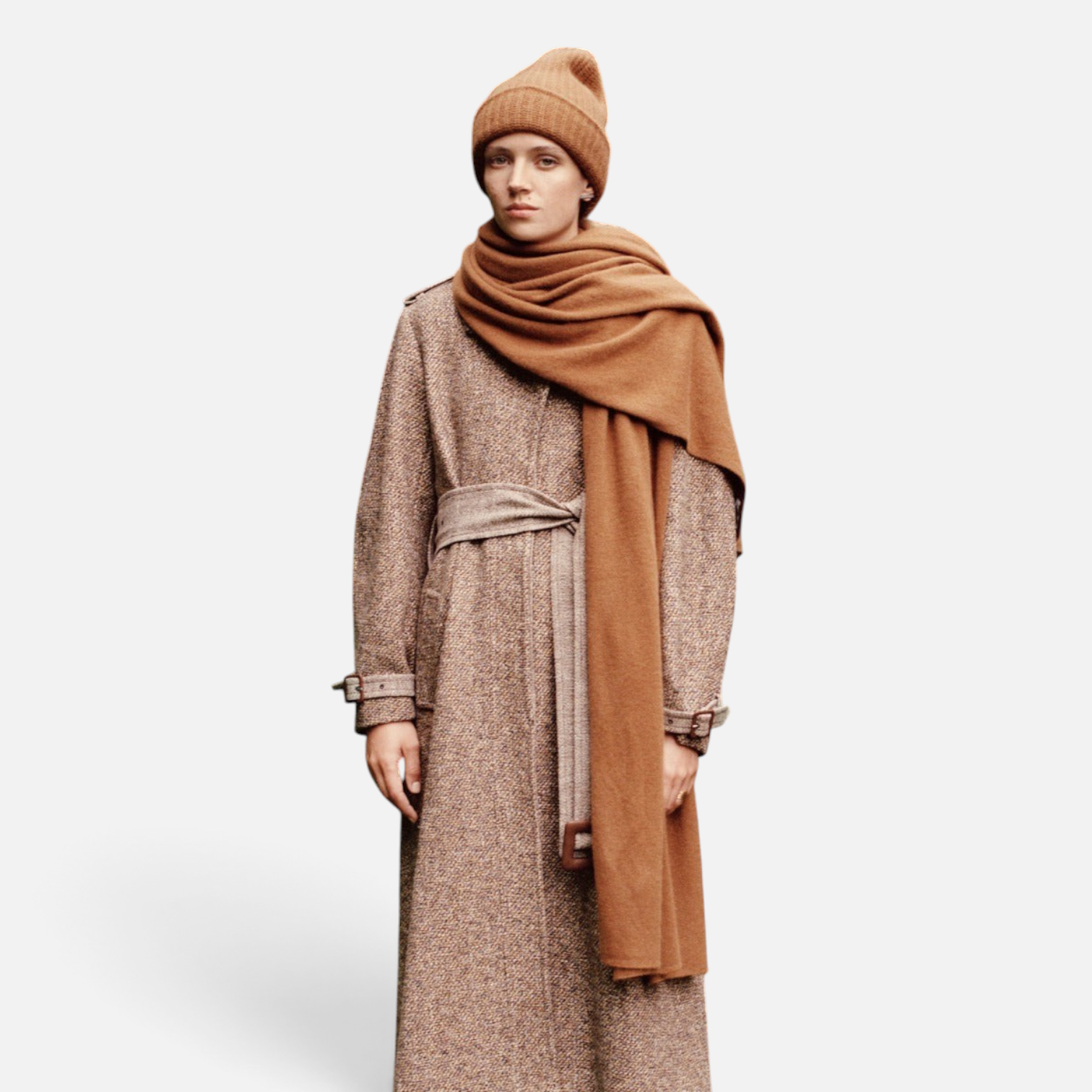 Shop Rescue Spa cashmere travel wrap in camel draped over a model wearing a matching beanie and tweed coat outdoors