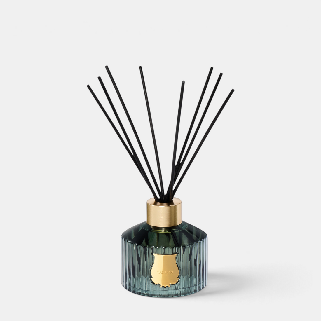 Shop Rescue Spa Trudon Figuerie home diffuser in a fluted green glass vessel with black reeds and gold emblem.