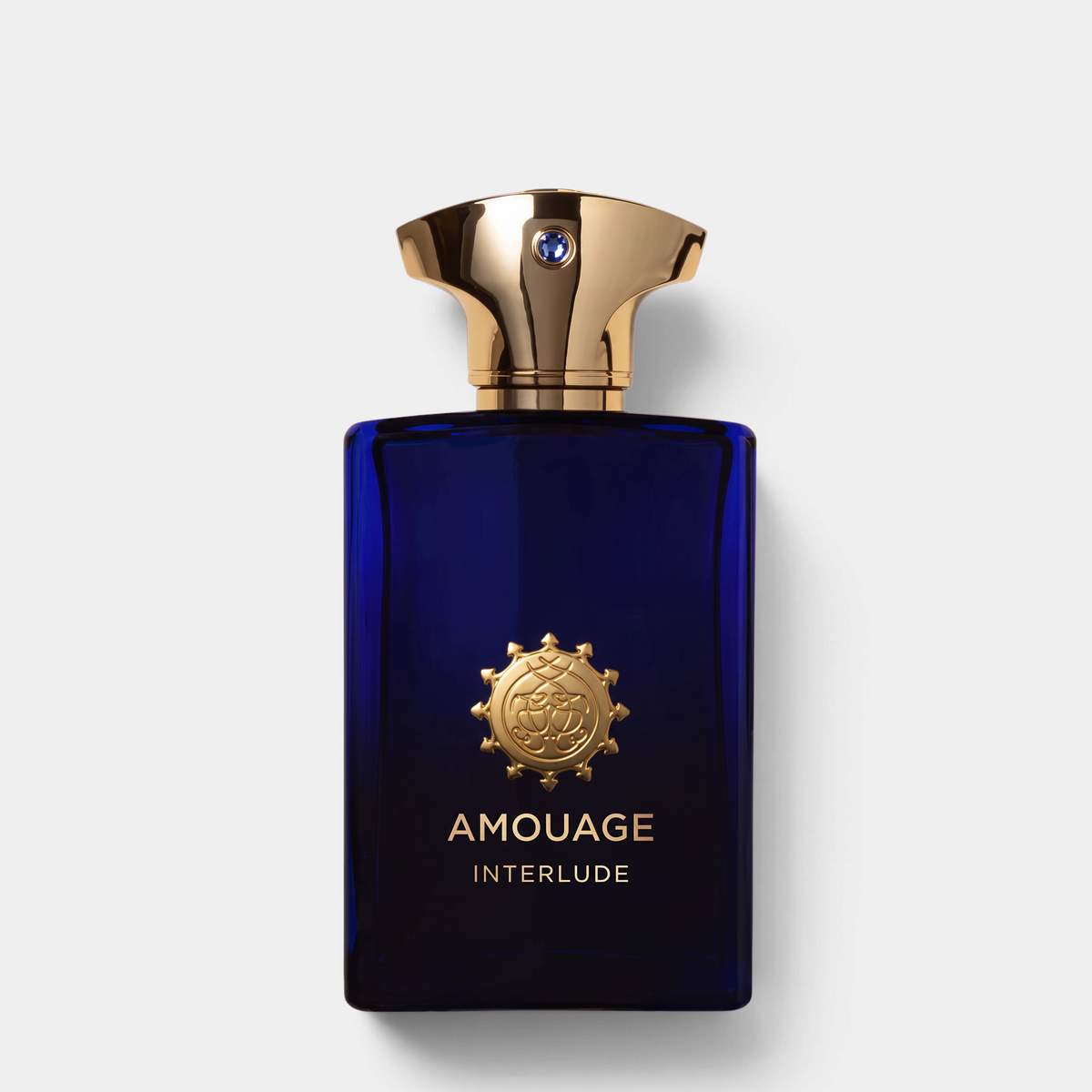 Shop Rescue Spa Amouage Interlude Man woody-spicy fragrance in a deep blue glass bottle with a gold cap