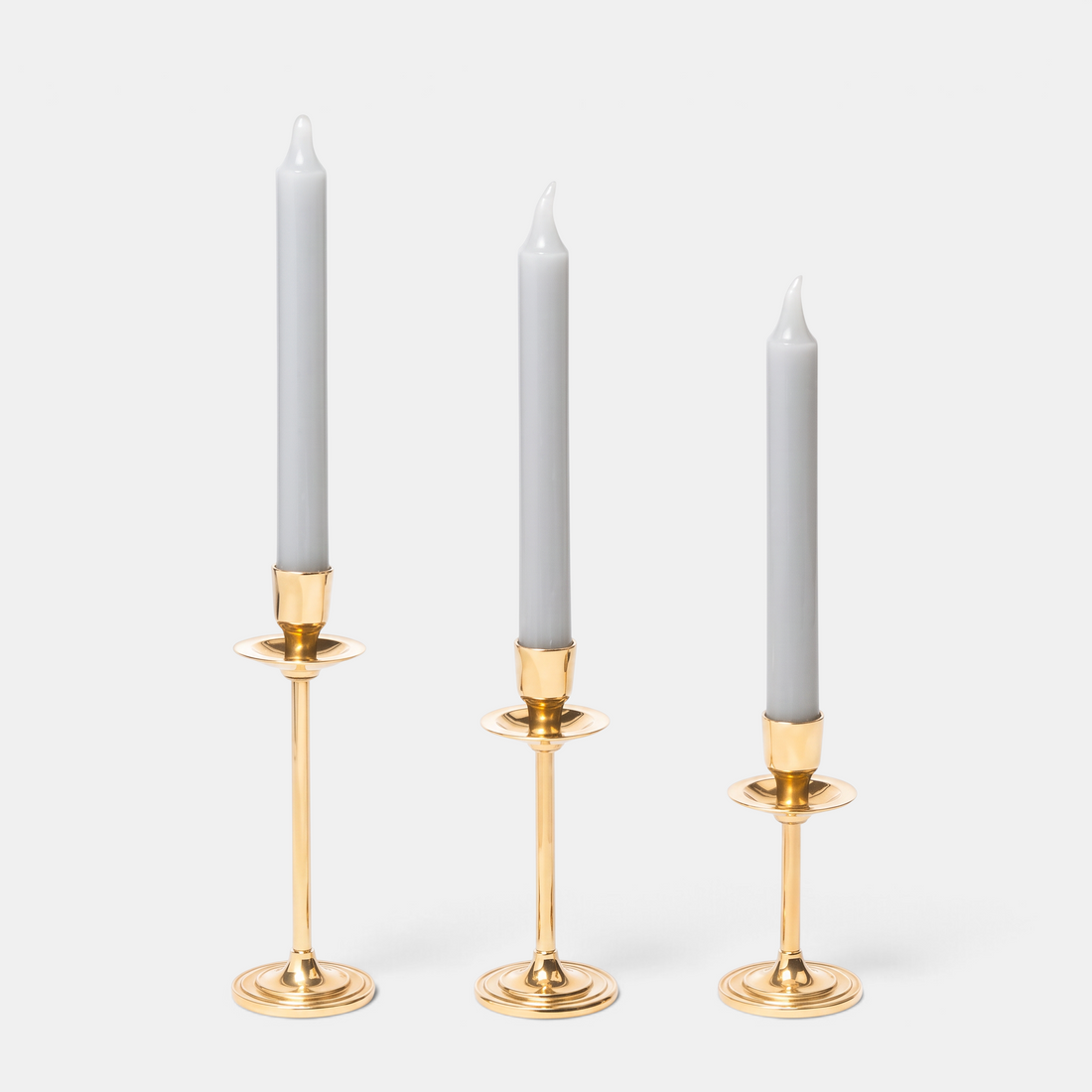 Shop Rescue Spa gold-plated candlestick trio in graduated heights with grey taper candles for elegant home decor