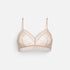 A light beige lace underwire bra with thin adjustable shoulder straps, displayed against a clean, light gray background.