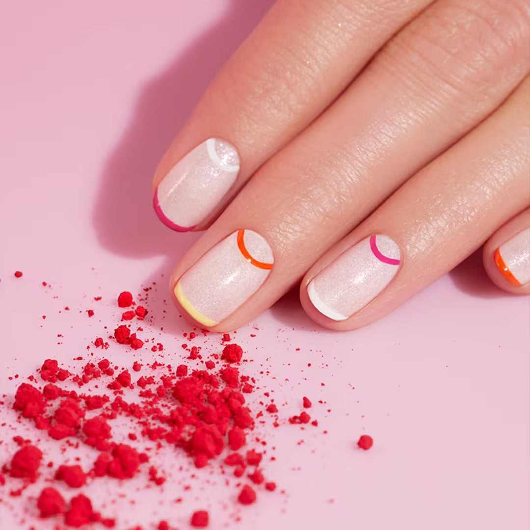Shop Rescue Spa Manucurist Green Flash gel manicure featuring a sheer base with colorful French and moon tip accents.