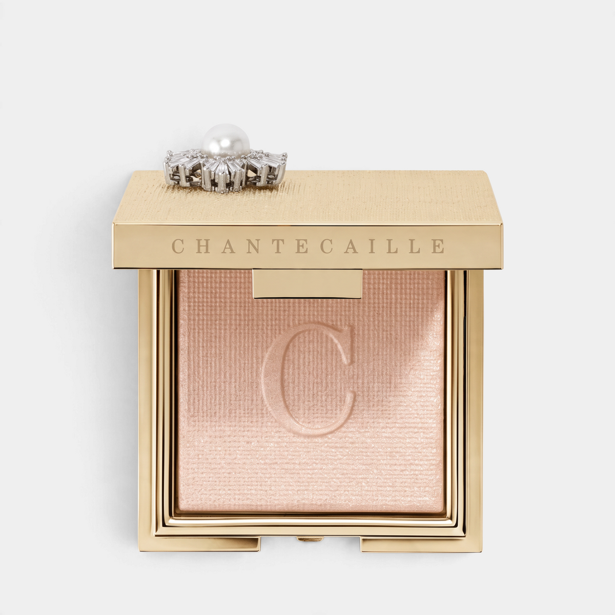 Shop Rescue Spa Cheek Light powder highlighter in Petale, a sheer pink shade with silver sheen in a gold compact.