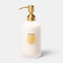 Shop Rescue Spa Trudon Médie scented hand lotion in a white ribbed bottle with a gold pump and signature gold emblem.