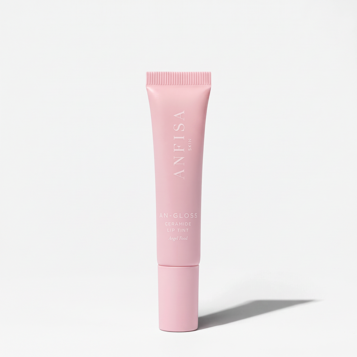 Shop Rescue Spa AN-GLOSS Ceramide Lip Tint in a soft pink squeeze tube with minimalist white branding.