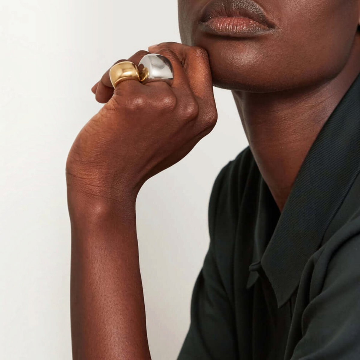 Shop Rescue Spa Tate gold signet ring worn on a finger with a sculptural rounded rectangular design