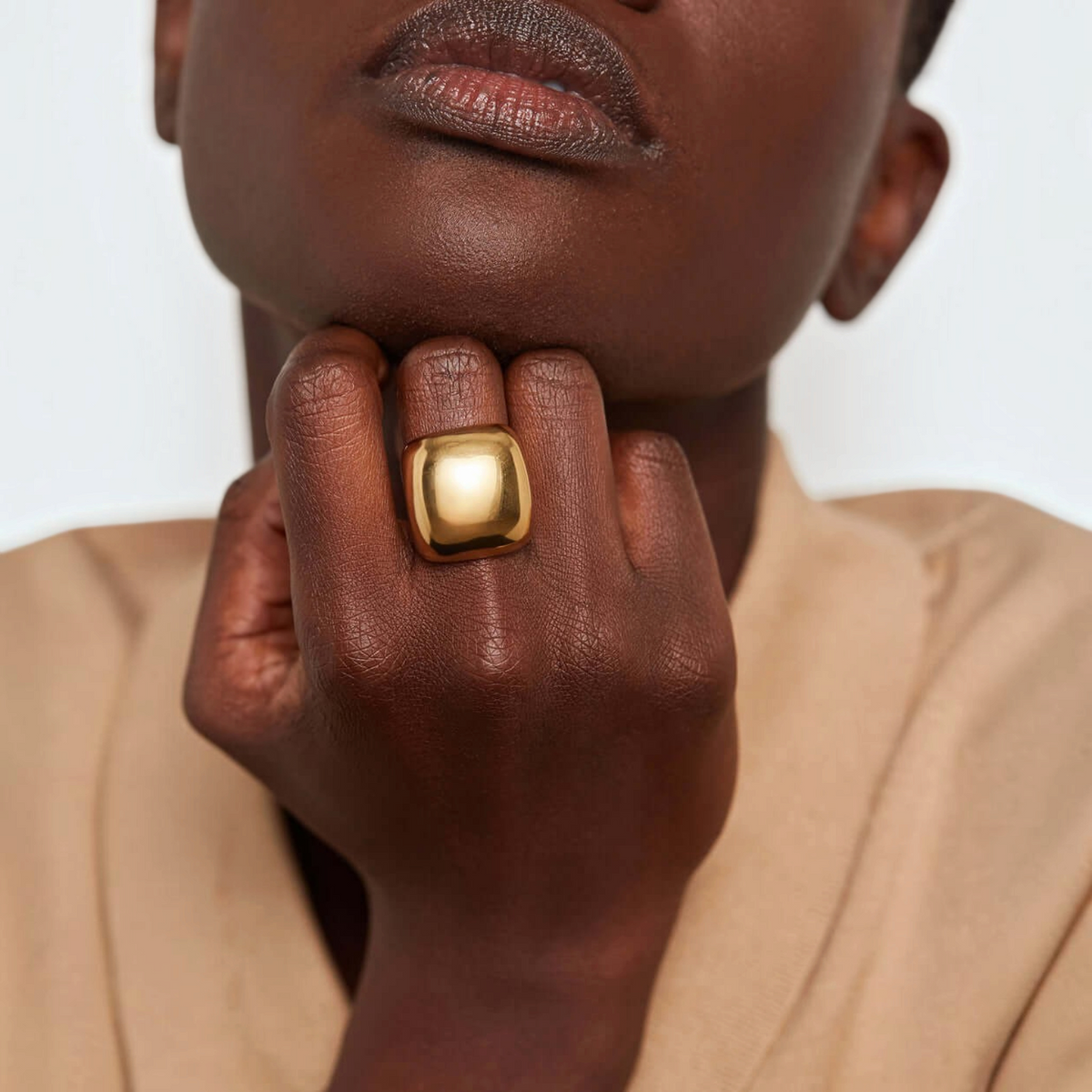 Shop Rescue Spa Tate Ring in high-polish gold with a bold, rounded rectangular sculptural design on a model&