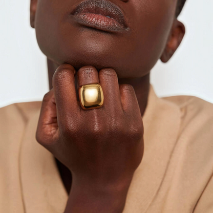 Shop Rescue Spa Tate Ring in high-polish gold with a bold, rounded rectangular sculptural design on a model&