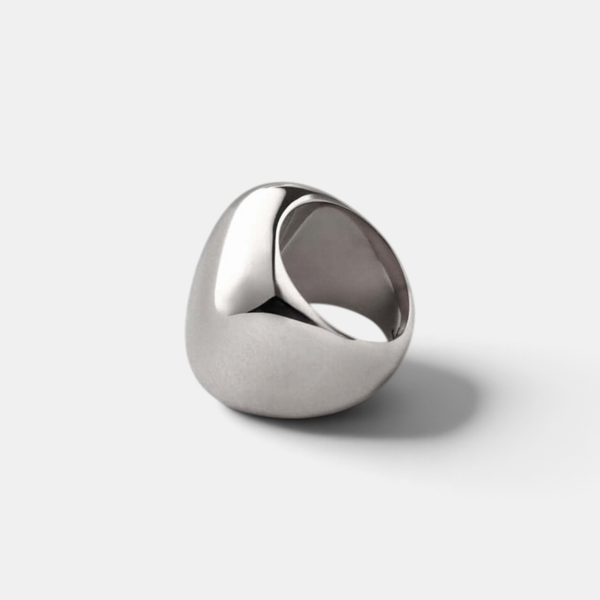 Shop Rescue Spa Tate Ring in high-polish platinum plated steel with a bold, rounded rectangular sculptural form.